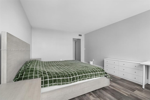 bedroom with visible vents and wood finished floors