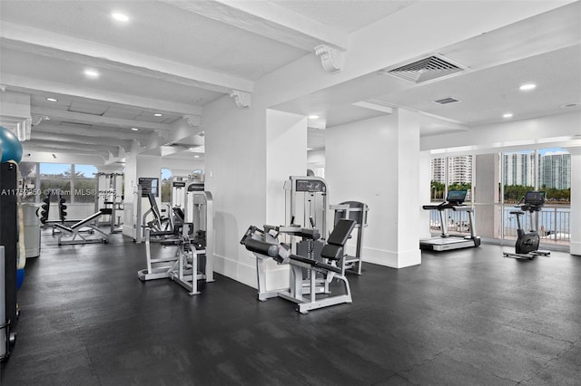 gym with baseboards, visible vents, a textured ceiling, and recessed lighting