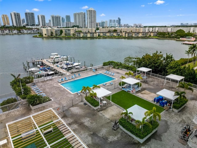 drone / aerial view featuring a city view and a water view