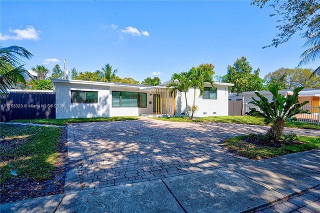 view of front of house featuring crawl space, fence, a gate, and stucco siding