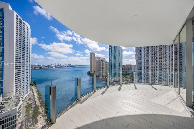 balcony featuring a view of city and a water view