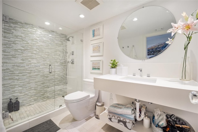 bathroom with toilet, a shower stall, visible vents, and recessed lighting