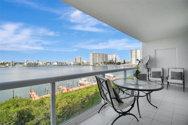 balcony featuring a water view and a city view