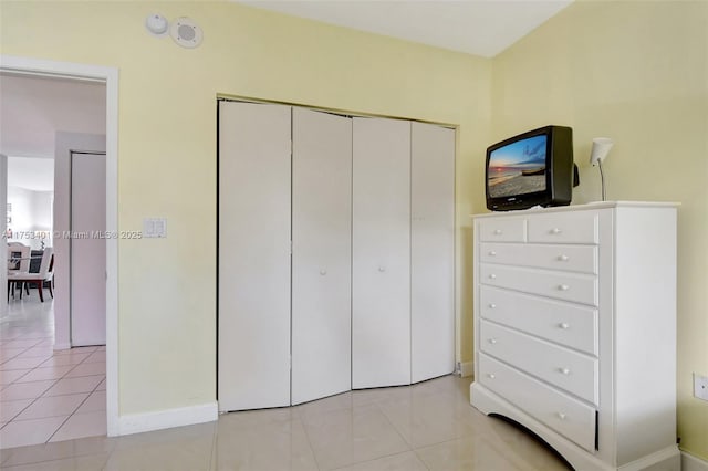 bedroom featuring a closet and light tile patterned flooring