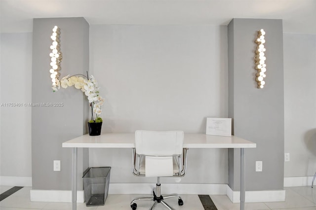 office space with baseboards and tile patterned floors