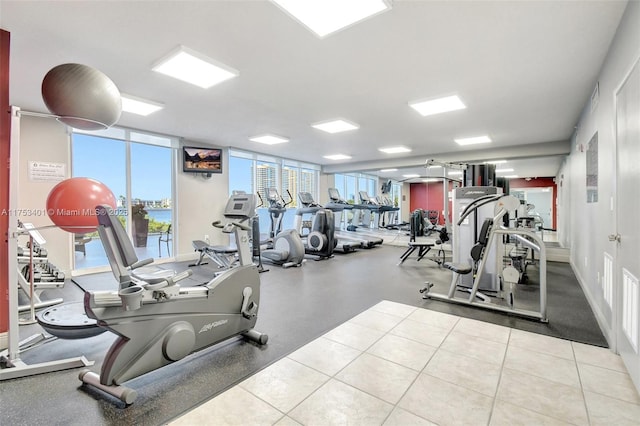 workout area with expansive windows, visible vents, and baseboards