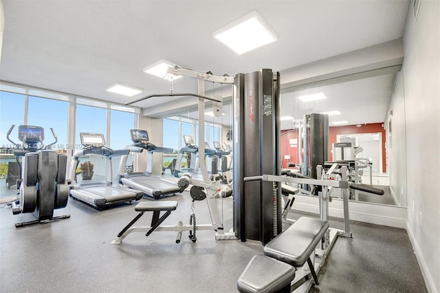 exercise room featuring baseboards and a wall of windows