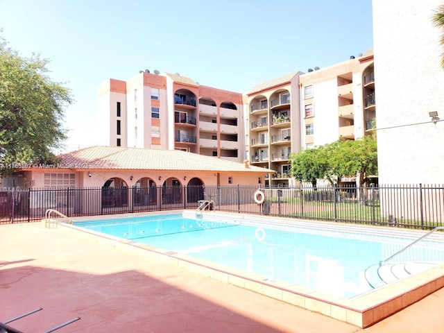 view of swimming pool featuring fence