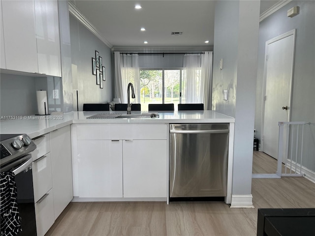 kitchen with dishwasher, range with electric cooktop, modern cabinets, and a sink