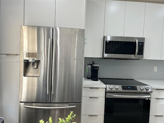 kitchen with light countertops, appliances with stainless steel finishes, modern cabinets, and white cabinetry