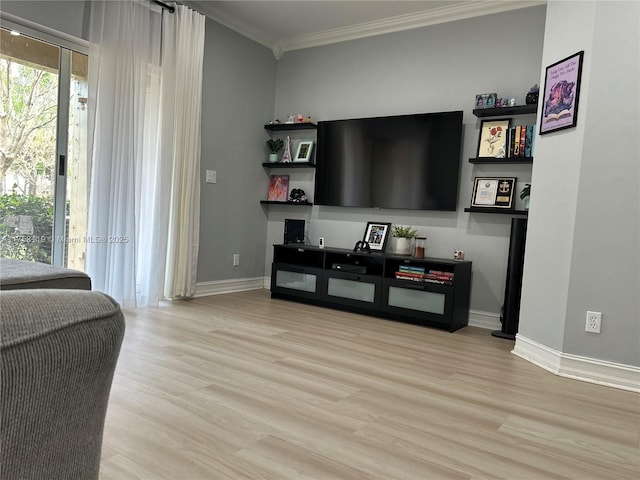 living room with light wood-type flooring, crown molding, and baseboards