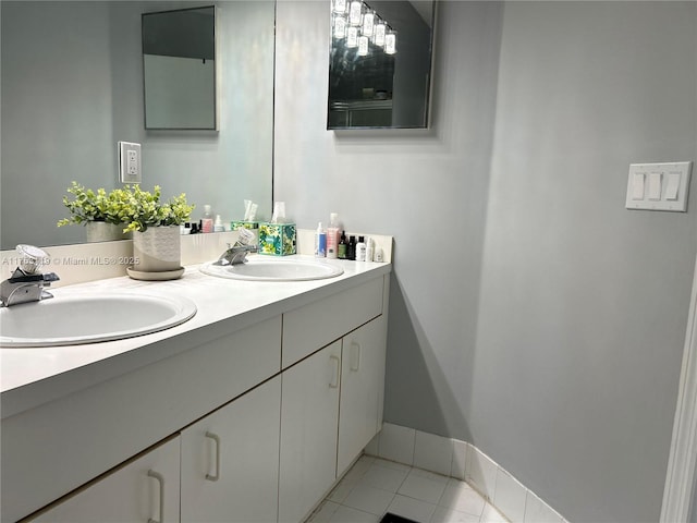 full bathroom with tile patterned flooring, a sink, baseboards, and double vanity