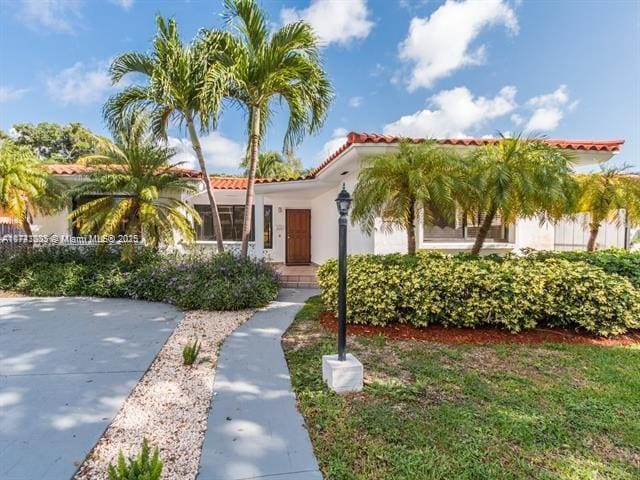 mediterranean / spanish house with a tiled roof and stucco siding