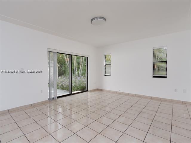 empty room with light tile patterned floors