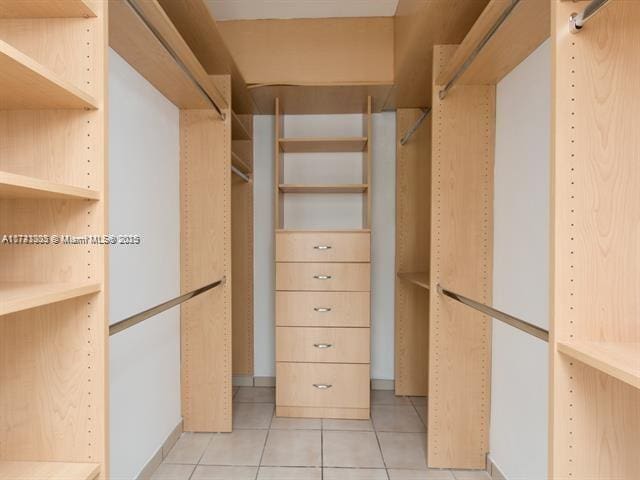 spacious closet featuring light tile patterned floors