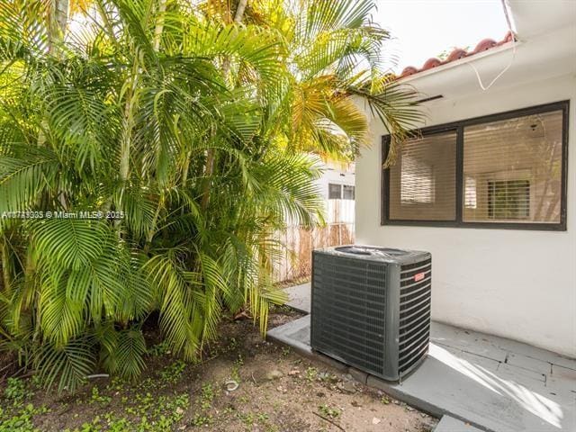 details featuring central AC unit and stucco siding