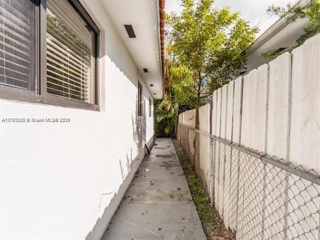 view of home's exterior with fence and stucco siding