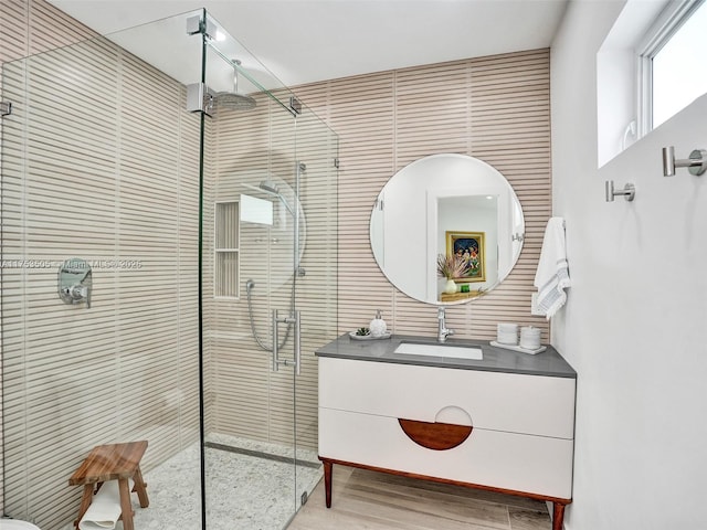 bathroom with a shower stall and vanity