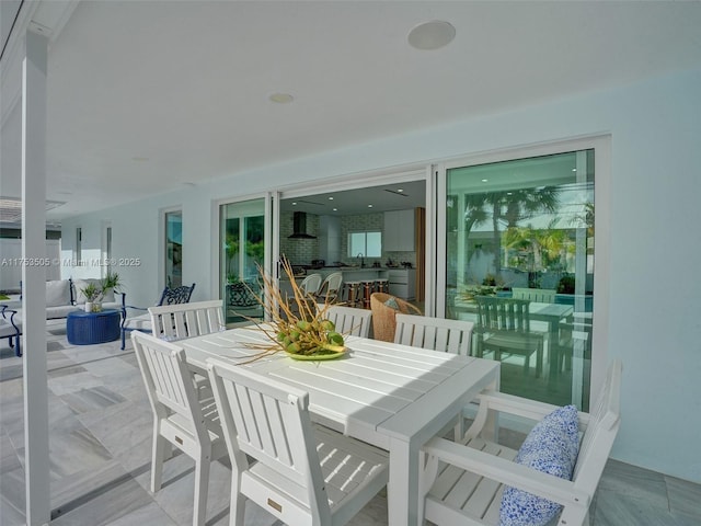 exterior space featuring outdoor dining space and a sink