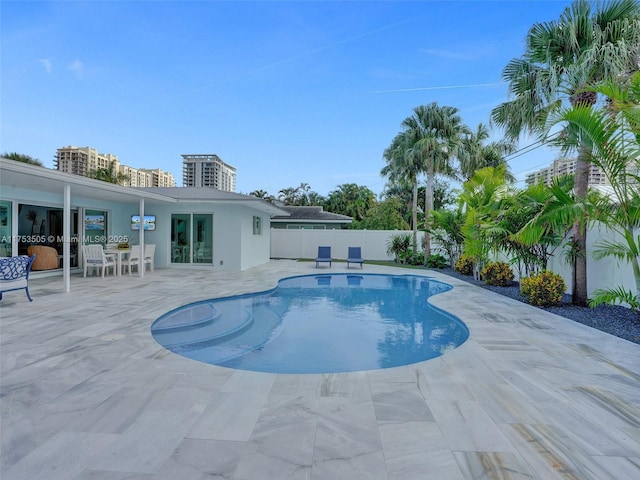 view of pool with a patio area, fence, and a fenced in pool