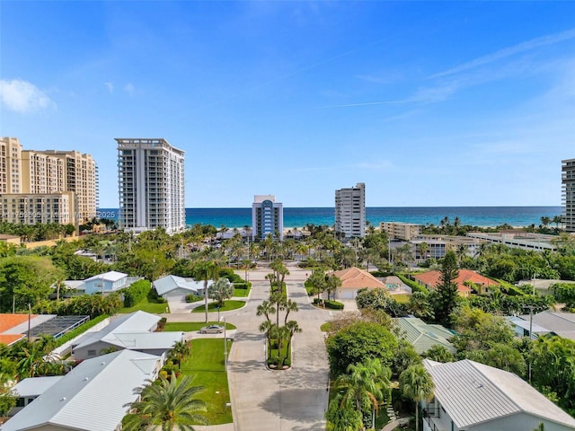 birds eye view of property with a water view and a city view