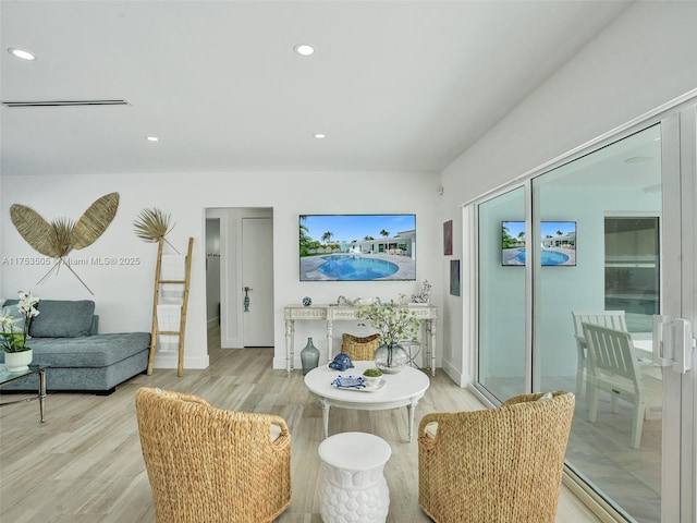 interior space with baseboards, light wood-style floors, visible vents, and recessed lighting