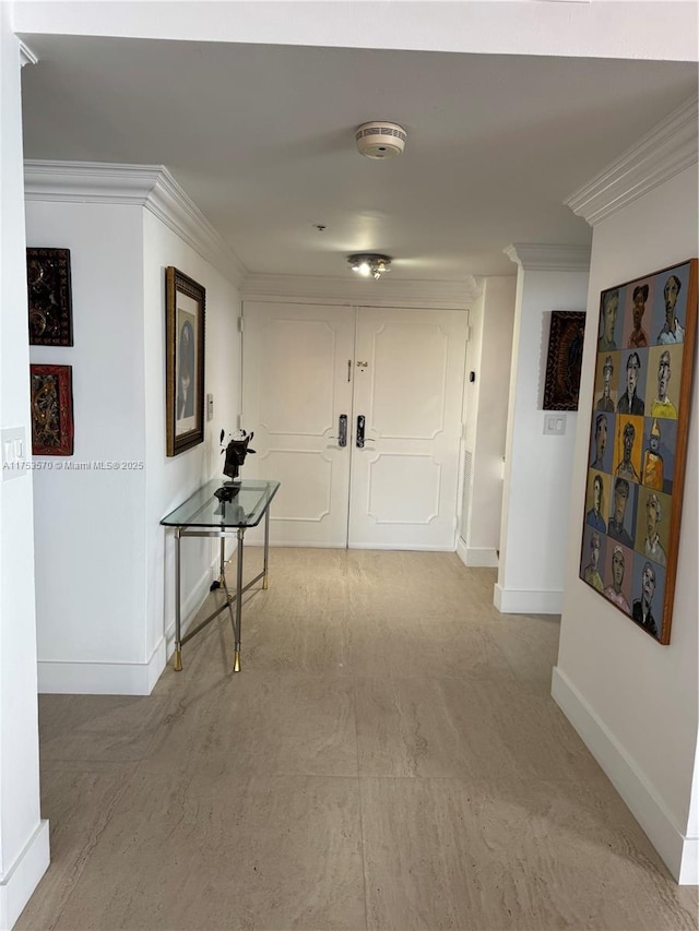 corridor featuring crown molding and baseboards