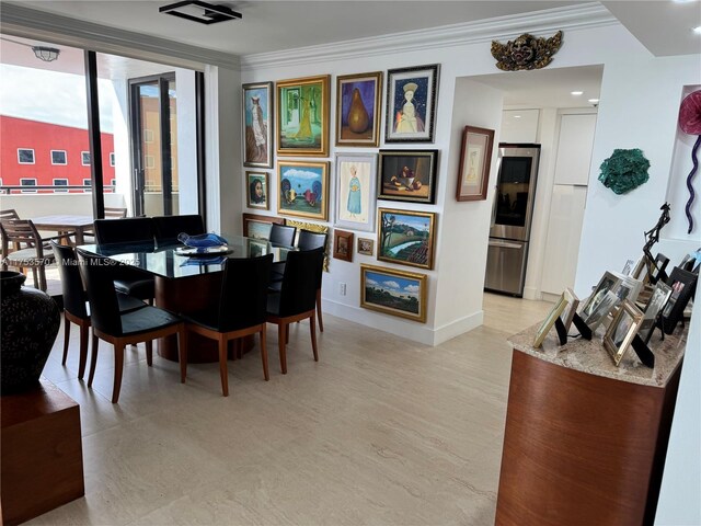 dining space featuring ornamental molding and baseboards
