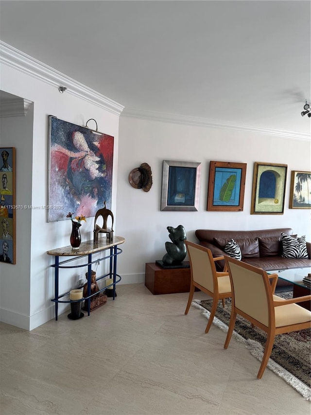 dining room featuring crown molding and baseboards