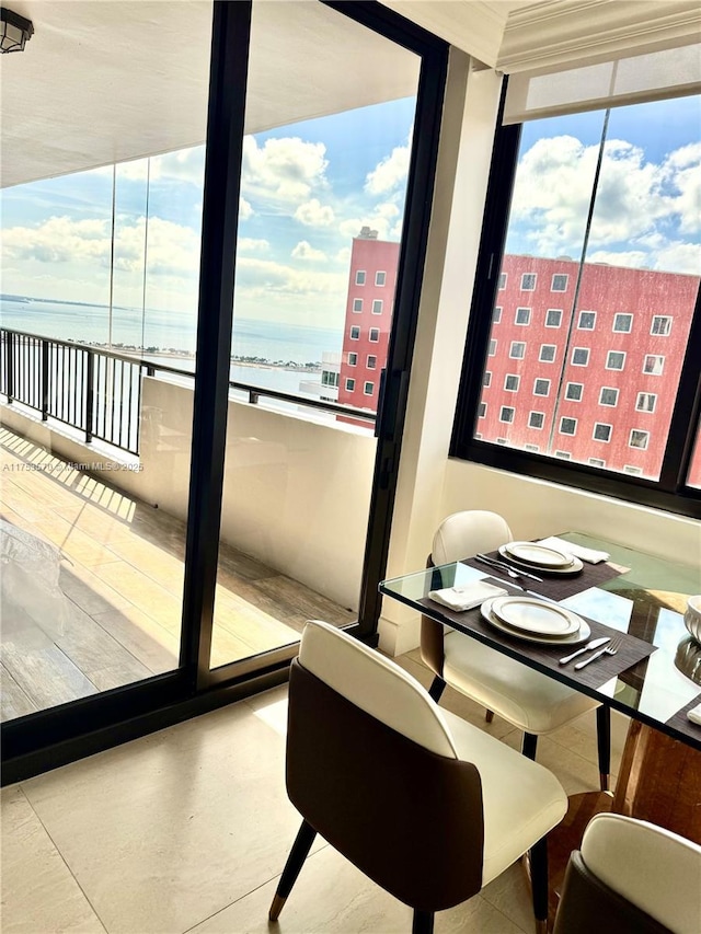 dining space featuring a wealth of natural light and a water view