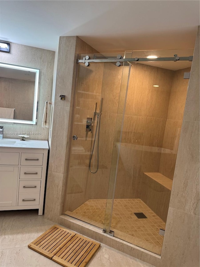 full bath with a shower stall and vanity