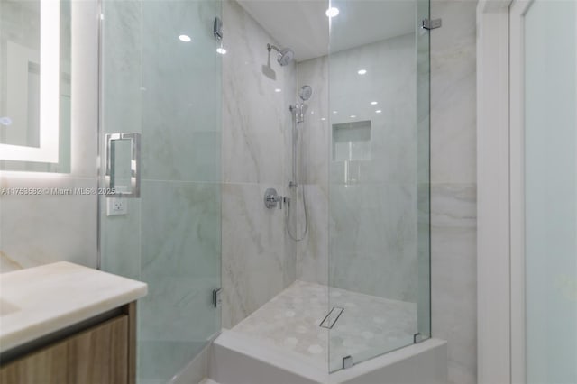 bathroom with a stall shower and vanity