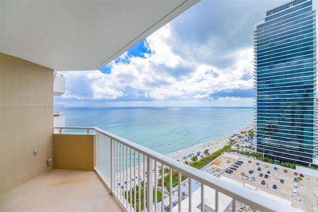 balcony with a beach view and a water view