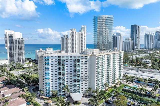 birds eye view of property featuring a water view and a city view