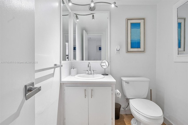 bathroom with toilet and vanity