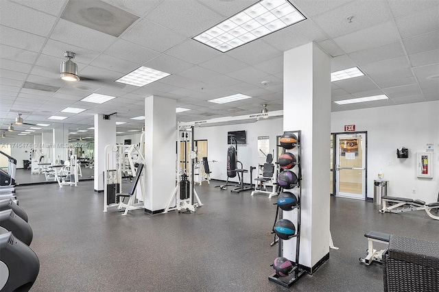 workout area with baseboards and a drop ceiling