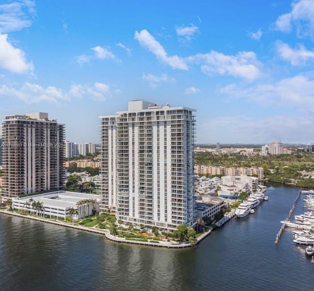 birds eye view of property featuring a view of city and a water view