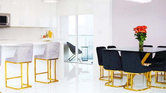 interior space featuring stainless steel microwave and white cabinets