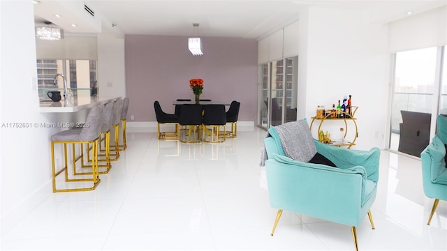 dining room with light tile patterned flooring, visible vents, and baseboards