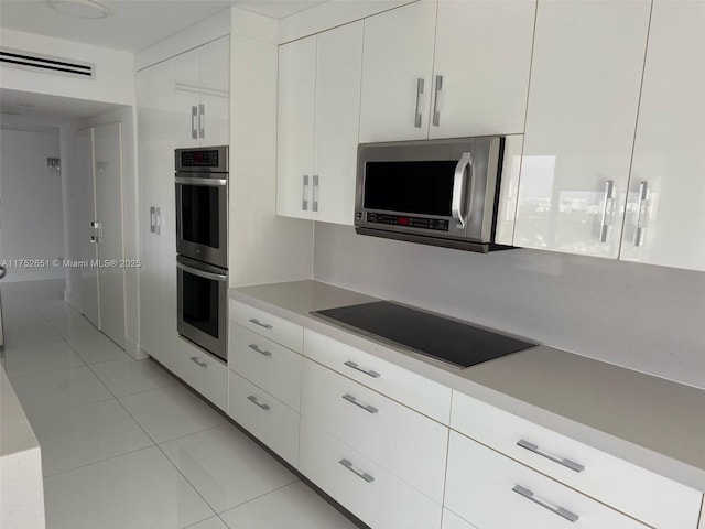 kitchen with white cabinets, visible vents, stainless steel appliances, and light countertops