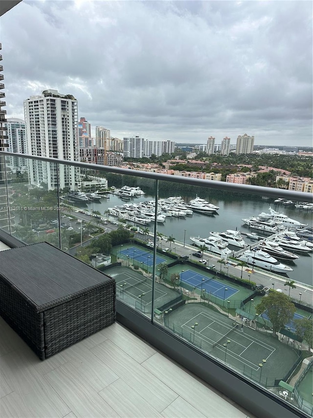 balcony featuring a water view and a view of city