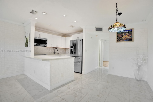 kitchen featuring marble finish floor, appliances with stainless steel finishes, a peninsula, and visible vents