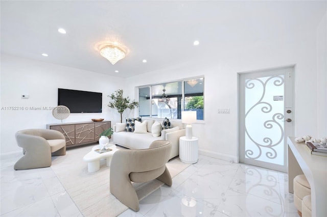 living area with baseboards, marble finish floor, and recessed lighting