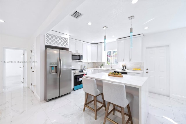 kitchen with stainless steel appliances, recessed lighting, marble finish floor, and visible vents