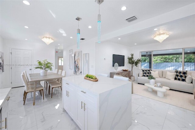 kitchen with open floor plan, marble finish floor, visible vents, and recessed lighting