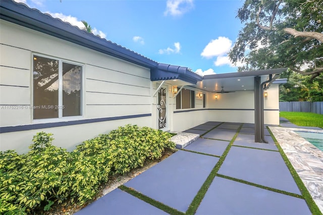 view of home's exterior with a fenced in pool, a patio area, fence, and stucco siding