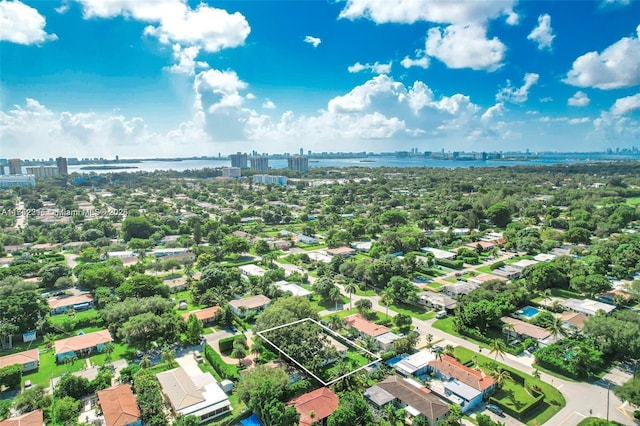 birds eye view of property with a water view and a city view