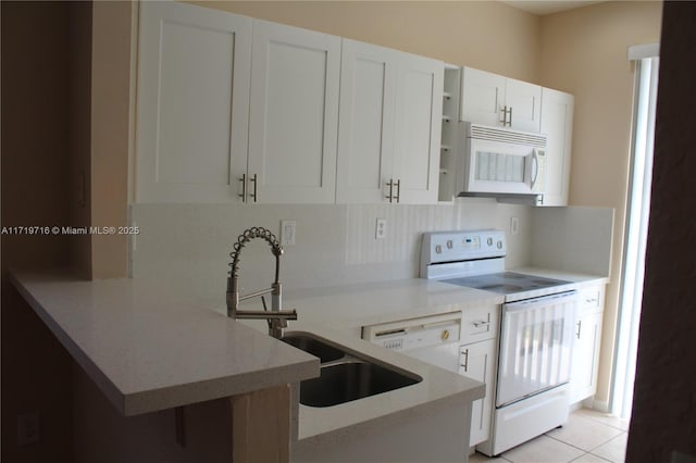 kitchen with a peninsula, white appliances, a sink, backsplash, and open shelves