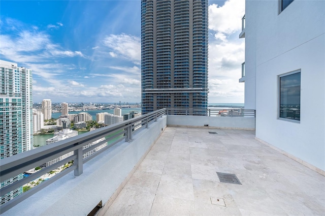 balcony with a water view and a city view