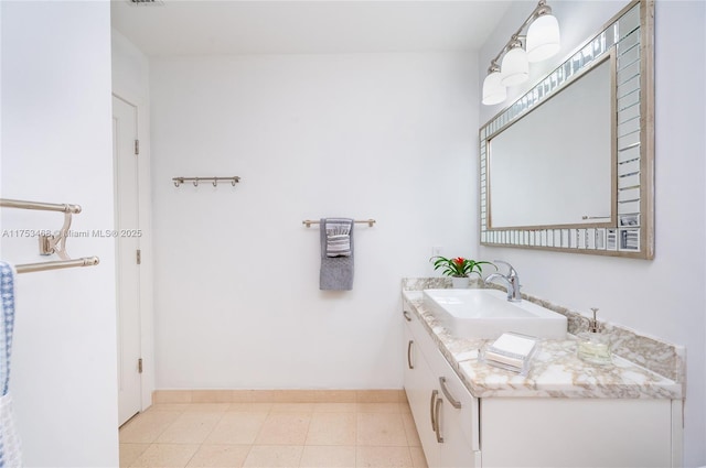 bathroom featuring visible vents, vanity, and baseboards